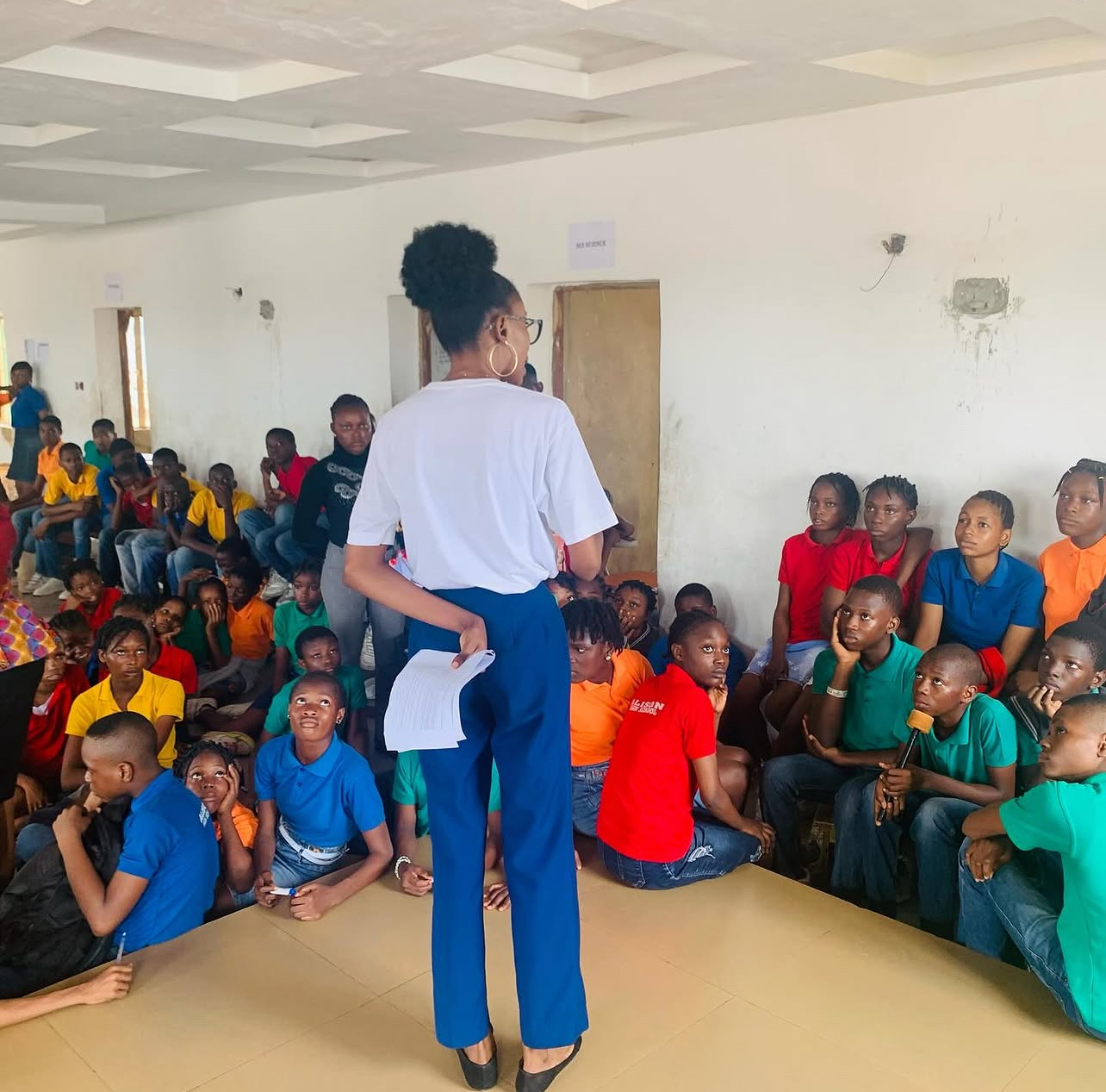 Anita addressing a large group of young students